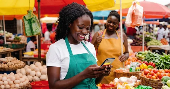Entrepreneur using mobile technology at a market